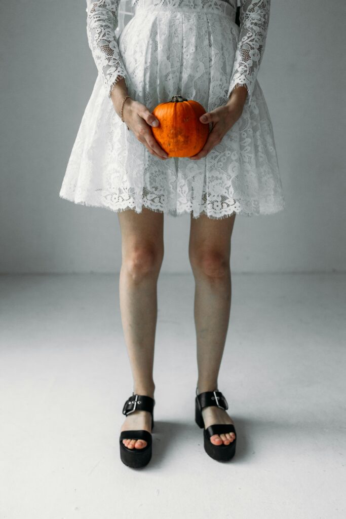 Ghost girl holding a pumpkin.